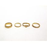 A 22 CARAT GOLD RING with an applied heart motif; with three 22 carat gold wedding rings; 12.8g