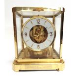 A JAEGER-LE-COUTRE 'ATMOS' CLOCK in gilt brass framed case with hinged front glass, white chapter