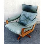 A NORWEGIAN 'SODA GALVANO' SWIVEL LOUNGE CHAIR with green patinated leather upholstery on a teak