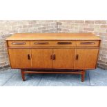 A G-PLAN 'FRESCO' TEAK SIDEBOARD fitted with three drawers above cupboards, 152cm long 46cm deep