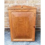 AN OAK HANGING WALL CUPBOARD the fielded panelled door fitted with two locks, 54 12 12