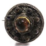 A SILVER BROOCH set with paste cabochon to tower like motifs with wire work decoration, in the style