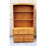 A NATHAN TEAK WALL UNIT with two adjustable shelves, four drawers over cupboards to base, 102cm wide