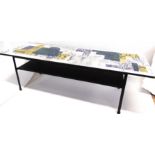 JOHN PIPER: A MID-20TH CENTURY FORMICA TOP COFFEE TABLE decorated with a London scene, on iron