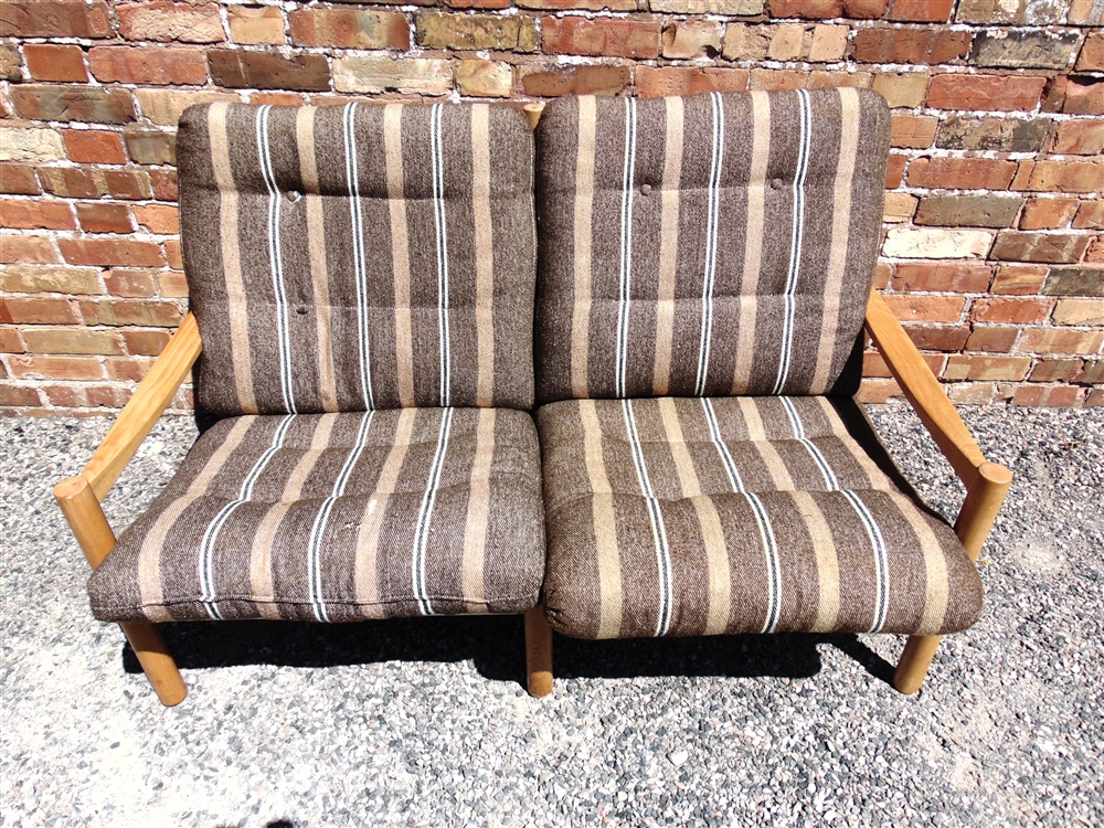 A 1970S BEECH FRAMED TWO SEATER SOFA with original cloth upholstery, 137cm wide