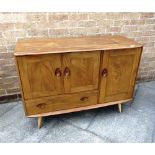 A SMALL ERCOL LIGHT ELM SIDEBOARD with cupboard above drawer beside further cupboard, 114cm wide