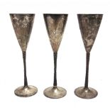 A TRIO OF STUART DEVLIN PARCEL GILT SILVER CHAMPAGNE FLUTES London 1978 and two for 1980, numbered