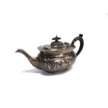 A SILVER TEAPOT by J Round, Sheffield 1911, of embossed rounded rectangular form, 24cm long, 351g (