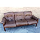 A DANISH THREE SEATER LEATHER UPHOLSTERED SOFA with stained beech frame, 210cm long