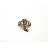 AN EDWARDIAN AMETHYST AND SEED PEARL PENDANT BROOCH indistinctly tagged, of quatrefoil design, 2.7cm