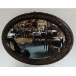 A BEVEL EDGED OVAL WALL MIRROR in moulded frame, 62cm x 88cm overall