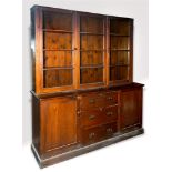 A LARGE STAINED PINE DRESSER/BOOKCASE the upper section the glazed doors enclosing two shelves,