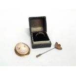 A PINK SHELL CAMEO BROOCH in a mount stamped '9ct', 9g gross; a synthetic stone set eternity ring,