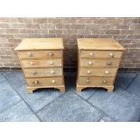 A PAIR OF SMALL PINE CHESTS OF DRAWERS each with four graduated drawers on bracket feet, 57cm wide