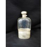 A SILVER MOUNTED GLASS HIP FLASK by J.C. Vickery, London 1900, pull off monogrammed cup base,