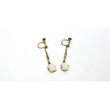 A PAIR OF OPAL DROP EARRINGS the rectangular cabochons to an open work suspension on a chain to