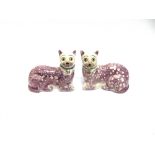 A PAIR OF STAFFORDSHIRE CATS with lustre decoration and glass eyes, 20cm long