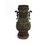 A CHINESE CAST METAL VASE relief moulded decoration, two handles modelled as animals, 36cm high,