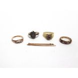 A 9 CARAT GOLD SYNTHETIC STONE SET CLUSTER RING three other stone set rings; and a bar brooch,