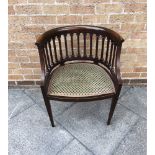 AN EDWARDIAN MAGHOGANY TUB ARMCHAIR on square tapering supports