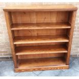 A PITCH PINE OPEN BOOKCASE with three adjustable shelves, 107cm wide 32cm deep 125cm high