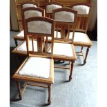 A SET OF SIX OAK DINING CHAIRS with upholstered seats and backs, and carved Art Nouveau style