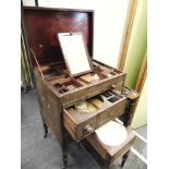 A GEORGE III GENTLEMANS MAHOGANY TRAVELLING VANITY CABINET the hinged lid opening to adjustable