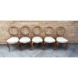 FIVE MATCHING VICTORIAN CARVED WALNUT BALLOON BACK CHAIRS on cabriole supports