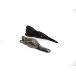 A PLATED DUCK HEAD PAPER CLIP with glass eyes, 16cm long; with a metal raven's head paper clip, with