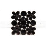 A 19TH CENTURY FLAT CUT GARNET BROOCH the stones closed back set, 4cm across, 8.7g gross