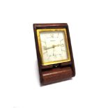 A JAEGER LE COULTRE 8 DAY TRAVELLING ALARM CLOCK in a folding leather covered case, numbered 098344,