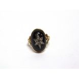 A VICTORIAN GARNET CARBUNCLE RING with a diamond set starburst centre, 1.9cm long, ring size N 1/