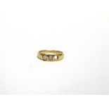 AN 18 CARAT GOLD THREE STONE DIAMOND RING the old cut brilliants totalling approximately 0.3 carats,