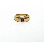 A SINGLE STONE GARNET RING stamped '18ct', the stone star set, the mount inscribed '24th May 1908'