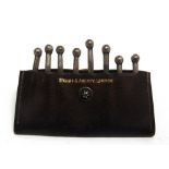 EIGHT SHOOTING PEG MARKERS contained in a leather wallet, by 'Swaine & Adeney, London', 7.5cm wide