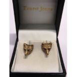 A PAIR OF 9 CARAT GOLD FOX MASK EARSTUDS by Crop & Furr, London 1961, with stone set eyes