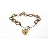 A 9 CARAT GOLD BRACELET of oval textural and kiss links, to a padlock clasp, 16g gross