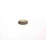 A DIAMOND HALF HOOP RING the yellow mount unmarked, set with two rows of nine single cut stones,