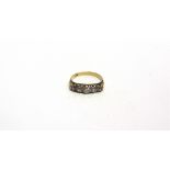 A FIVE STONE DIAMOND RING stamped '18ct', the graduated old cuts totalling approximately 0.9 carats,