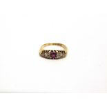 AN EDWARDIAN RUBY AND DIAMOND RING Birmingham 1906, the centre ruby flanked either side by five