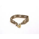 A 9 CARAT GOLD FIVE BAR BRACELET to a padlock clasp, 27g gross