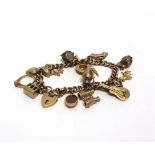 A 9 CARAT GOLD BRACELET of solid curb links, with seventeen various charms attached, to a padlock