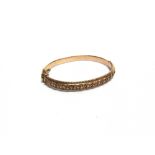 A LATE VICTORIAN 15 CARAT GOLD HINGED BANGLE hallmarks worn, 0.8cm wide, internal diameter 6.1cm,