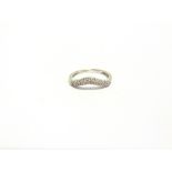 A DIAMOND SET 18 CARAT WHITE GOLD DIAMONDS SET HALF HOOP RING with a line of single cuts and a