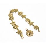 A FILIGREE BRACELET stamped '14K' to the catch, of alternating star and circular shaped panels; with