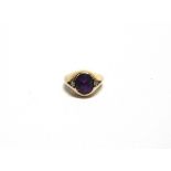 AN AMETHYST RING stamped '9ct', with a single cut diamond to each shoulder, finger size G, 5.5g