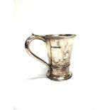 A SILVER MUG by Northern Goldsmith Co, Birmingham 1934, the tapering body with S scroll handle, 13.