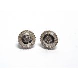 A PAIR OF DIAMOND CLUSTER EARSTUDS unmarked, the central brilliant cut of approximately 0.15 carats,