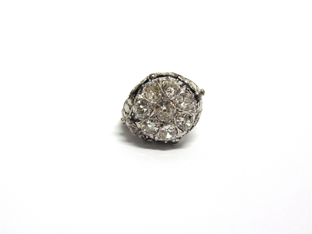 AN EIGHT STONE DIAMOND CLUSTER RING the white mount unmarked, the central old brilliant cut of - Image 2 of 3
