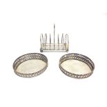 A PAIR OF DUTCH COASTERS with low pierced sides, 9.7cm diameter and a Dutch toast rack; 247g (7.9